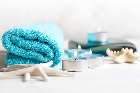 SPA still life with towel, candles and starfish on white wooden  surfaceの写真素材