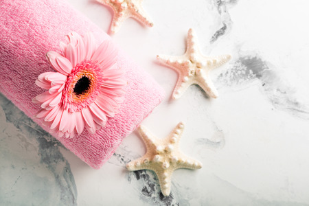 SPA still life with towel, candles and gerberas flower on a dark wooden surfaceの写真素材