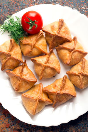 Baked samosa prepared from dough with filling (vegetables or meat)の写真素材