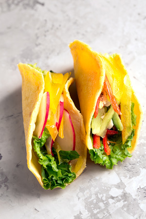 Taco with fresh vegetables on a grey surfaceの写真素材