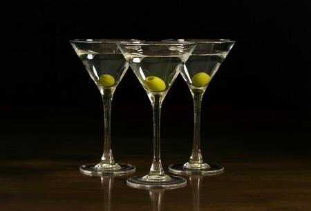 Three glasses with a martini cocktail on a black backgroundの写真素材