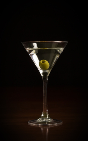 Glass of martini cocktail on a black backgroundの写真素材
