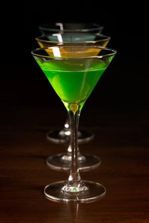Three glasses of colorful cocktails on a black backgroundの写真素材