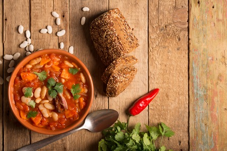 Rustic Kidney Bean Soup with beans and carrot. On the wooden table with copy spaceの写真素材