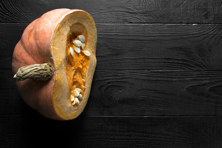 Pumpkins on the black wooden background. Horizontal orientation with copy spaceの写真素材