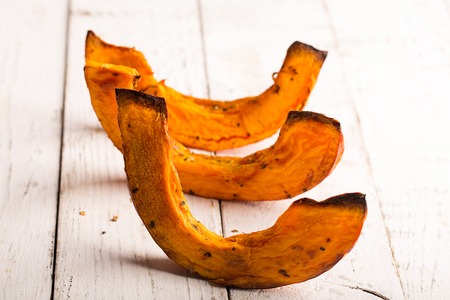 Baked pumpkin on the white wooden table.の写真素材