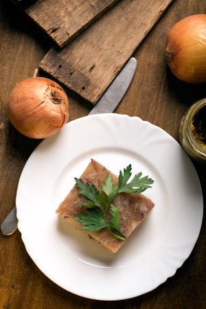 Jellied meat on a dark wooden background, Top view, rustic style