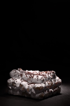 Delicious white cake on the black background with copy spaceの写真素材