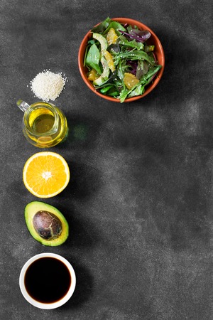 Fresh salad with avocado and orange, sprinkled with sesame seedsの写真素材