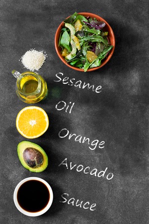 Fresh salad with avocado and orange, sprinkled with sesame seedsの写真素材