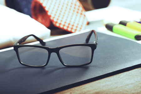 Business objects on the desk,including digital tablet, shirt, ties, lunch box, paper and pencils, top viewの写真素材