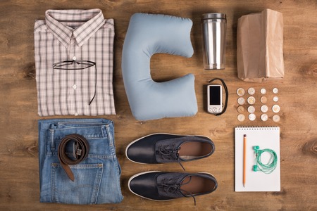 Vacation items on the table, top view.Clothing, shoes, camera and money as a travel elementsの写真素材