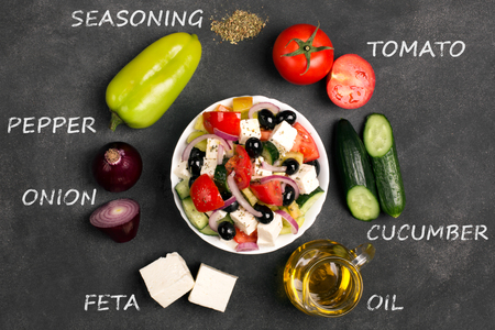 Greek salad ingredients: fresh vegetables, feta cheese and black olives on the chalkboard. Top viewの写真素材