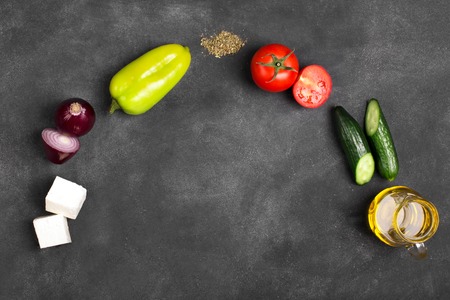 Greek salad ingredients: fresh vegetables, feta cheese and black olives on the chalkboardの写真素材
