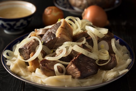 National Kazakh dish - Beshparmak prepared with boiled meat, pasta and onuinの写真素材