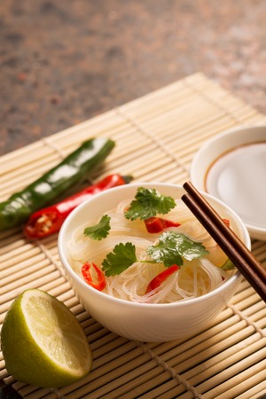 Chinese noodle with chili pepper and cilantro. Copy spaceの写真素材