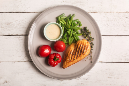 Marinated grilled healthy chicken breast served with vegetablesの写真素材