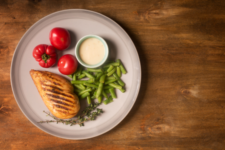 Marinated grilled healthy chicken breast served with vegetables. Top view, copy spaceの写真素材