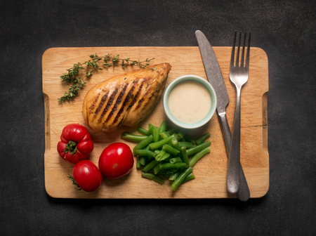 Marinated grilled healthy chicken breast served with vegetablesの写真素材