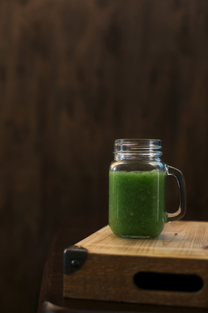 Healthy green smoothie on a wooden table. Selective focusの写真素材