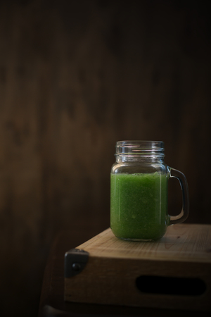 Healthy green smoothie on a wooden table. Selective focusの写真素材