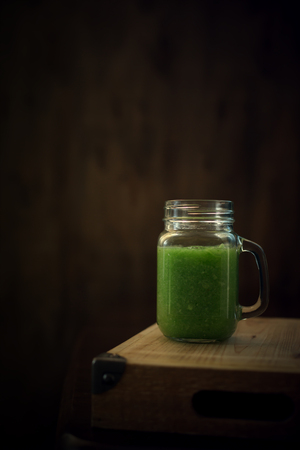 Healthy green smoothie on a wooden table. Wooden backgroundの写真素材