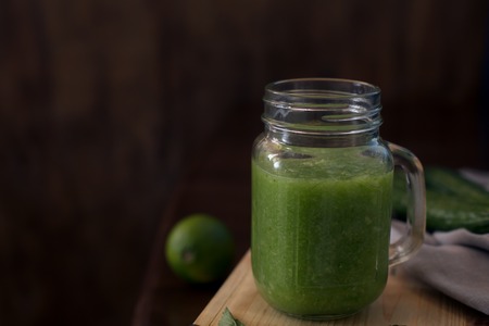 Healthy green smoothie on a wooden table. Selective focusの写真素材