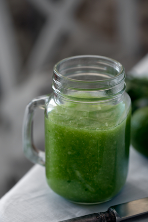 Fresh organic green smoothie with spinach, cucumber on a white tableware. Close upの写真素材