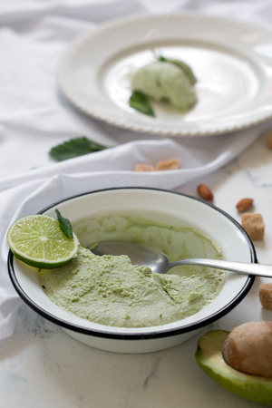 Hand made tasty ice cream prepared with avocado. Served with mintの写真素材