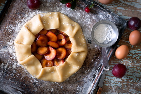 Traditional rustic cake prepared from dough and plum.Top viewの写真素材