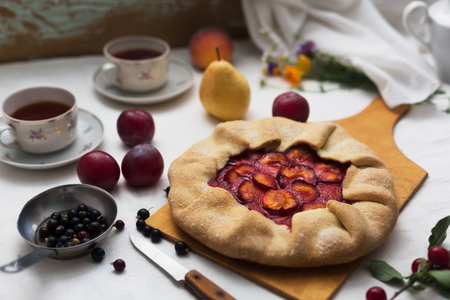 Traditional rustic cake prepared from dough and plum. Still life in rustic styleの写真素材