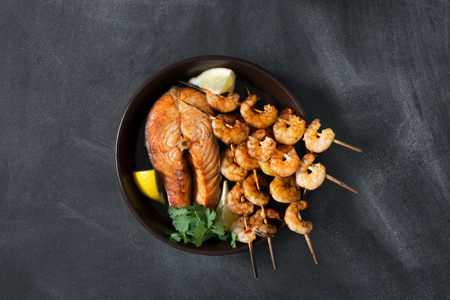 Prepared seafood on the black chalkboardの写真素材