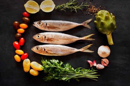 Mediterranean fish - and vegetables on the chalkboard. top viewの写真素材
