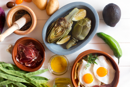 Fresh prepared food and raw ingredients on the white wooden background.の写真素材