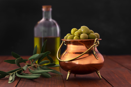 Fresh green olives on the wooden backgroundの写真素材