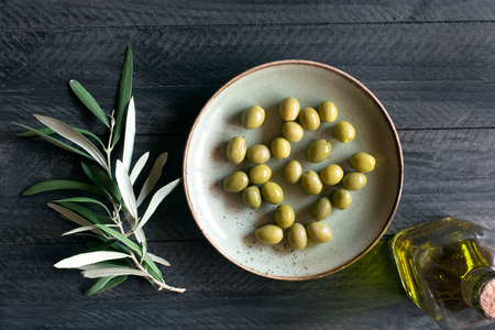 Fresh green olives on the wooden backgroundの写真素材