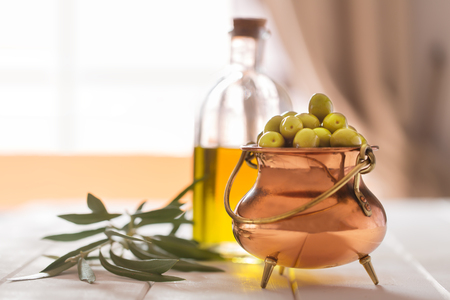 Fresh green olives on the wooden backgroundの写真素材