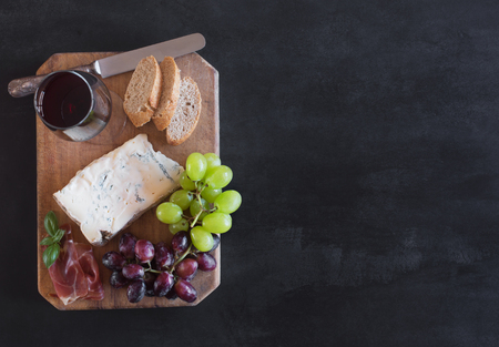 Piece of Spanish Blue cheese on an old wooden cutting board, copy spaceの写真素材