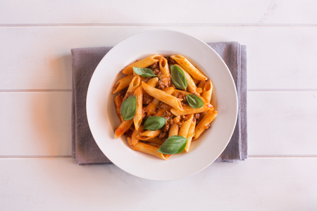 Italian Penne pasta with Bolognese sauce top view. Horizontal orientationの写真素材