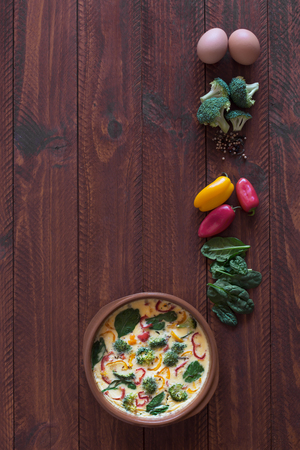 Fresh omelette prepared with vegetables and spinach. Top view. Vertical orientationの写真素材