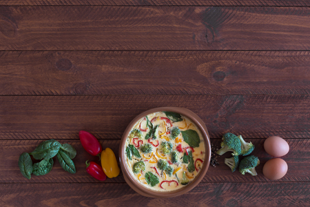 Fresh omelette prepared with vegetables and spinach on the tableの写真素材