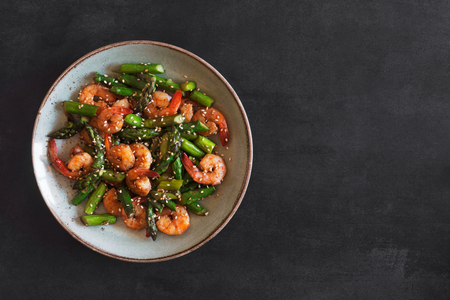 Salad with asparagus and shrimps in plateの写真素材