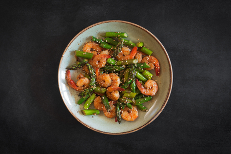 Salad with asparagus and shrimps in plate. Central compositionの写真素材