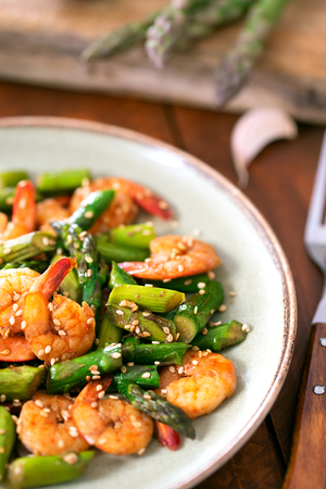 Salad with asparagus and shrimps in plateの写真素材