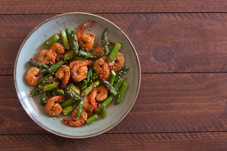 Salad with asparagus and shrimps in plateの写真素材