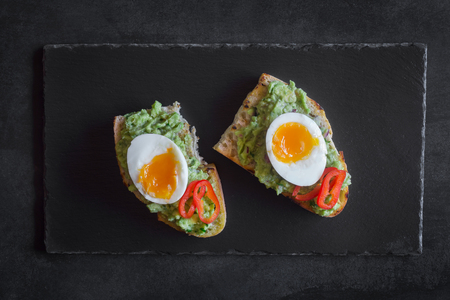 Healthy breakfast- sandwich prepared with guacamole, pepper and boiled chicken eggの写真素材