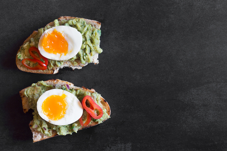 Healthy breakfast- sandwich prepared with guacamole, pepper and boiled chicken eggの写真素材