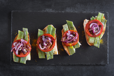 Summer sandwich prepared with fried red onion, tomato and kidney beansの写真素材