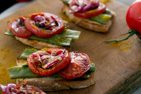 Summer sandwich prepared with fried red onion, tomato and kidney beans. Selective focusの写真素材