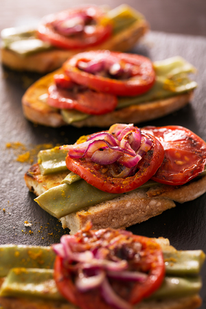 Summer sandwich prepared with fried red onion, tomato and kidney beans. Selective focusの写真素材